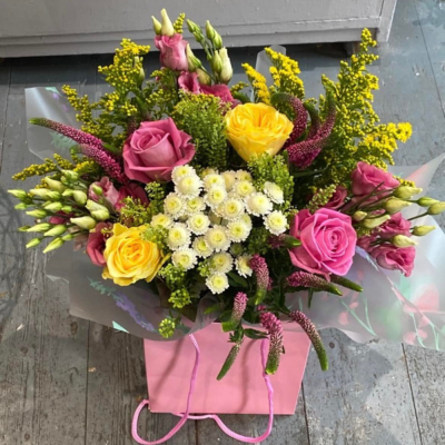 Hidden Treasure - An outstanding hand tied bouquet with a cascade of colour and a treasure chest overflowing with the beautiful flowers.