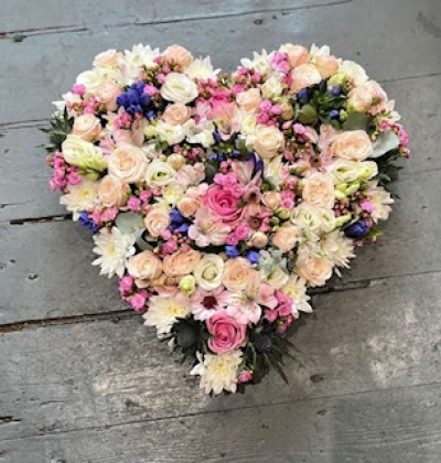 Light hearted - Heart shaped tributes in mixed seasonal flowers