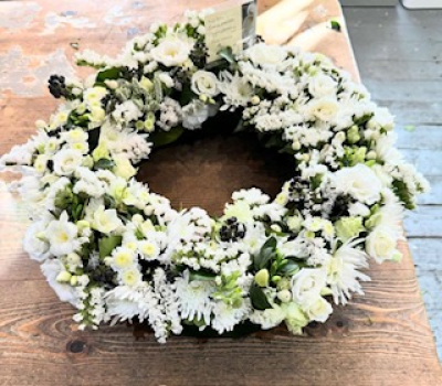 Snowflake wreath - Wreath of beautiful fresh white flowers and green foliages
